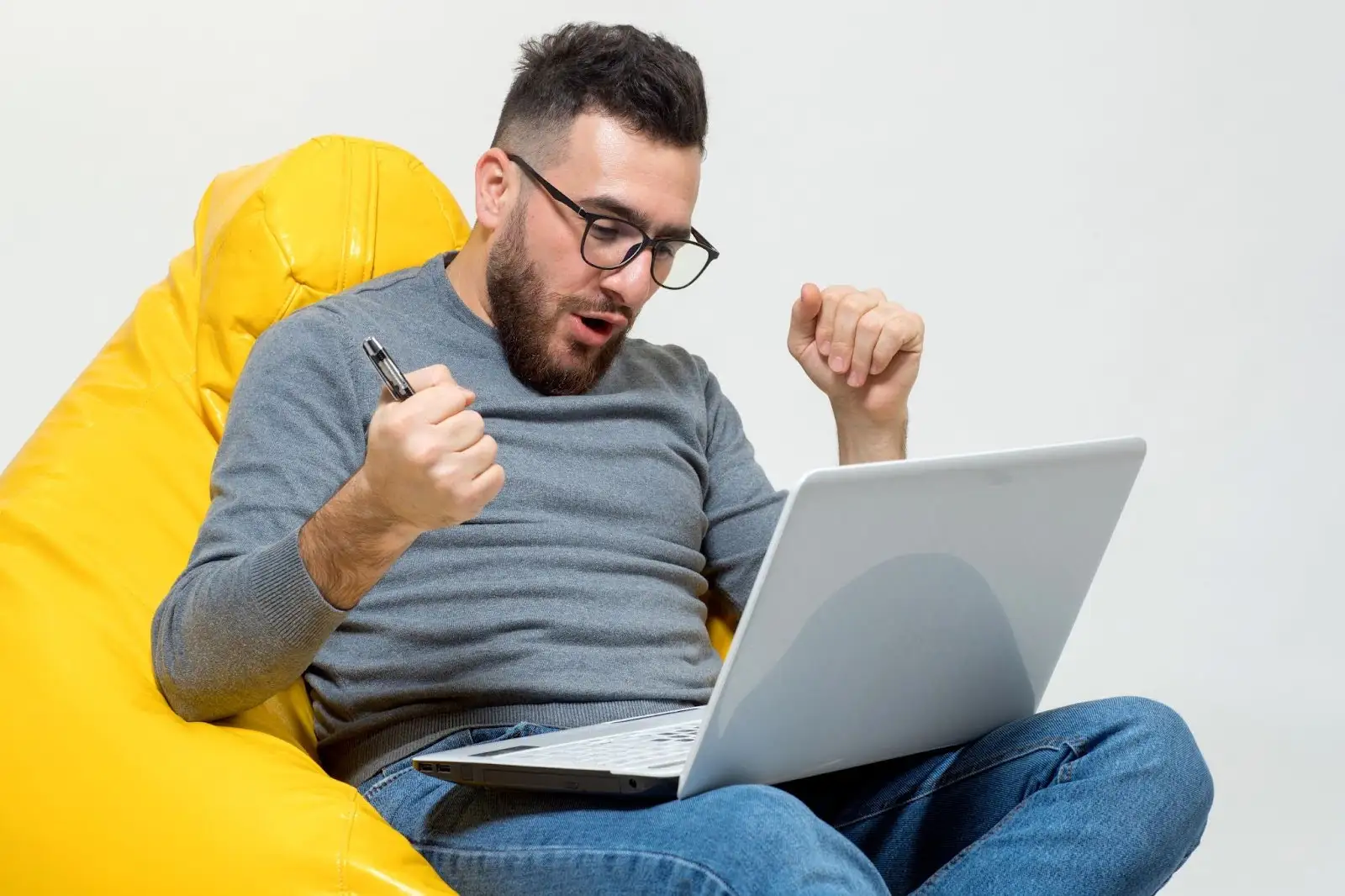 Guy sitting on a bean bag using a laptop, representing Spectrum Internet Prices in Jacksonville and breaking down the numbers