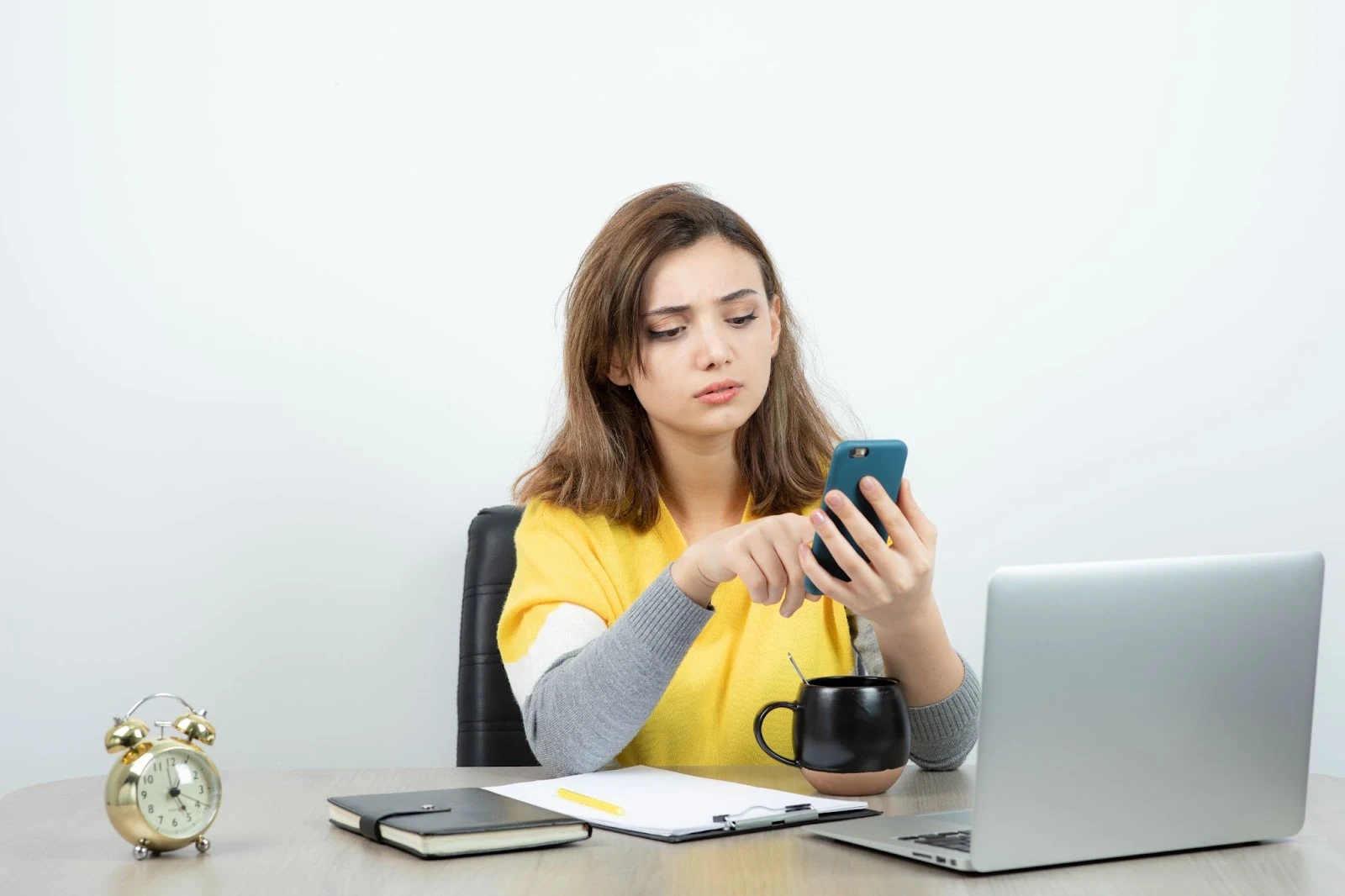 An anxious young woman holding her phone while using mobile internet, reflecting financial stress, paired with the theme “Spectrum Free Internet: Because Your Bank Account Is Already Begging.”