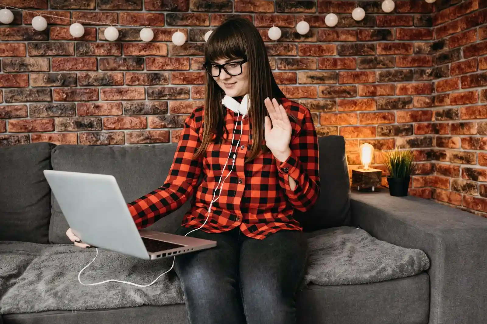 A girl using a laptop, focused on browsing the internet representing The Brutal Truth About Windstream Fiber Optic Internet' displayed nearby.