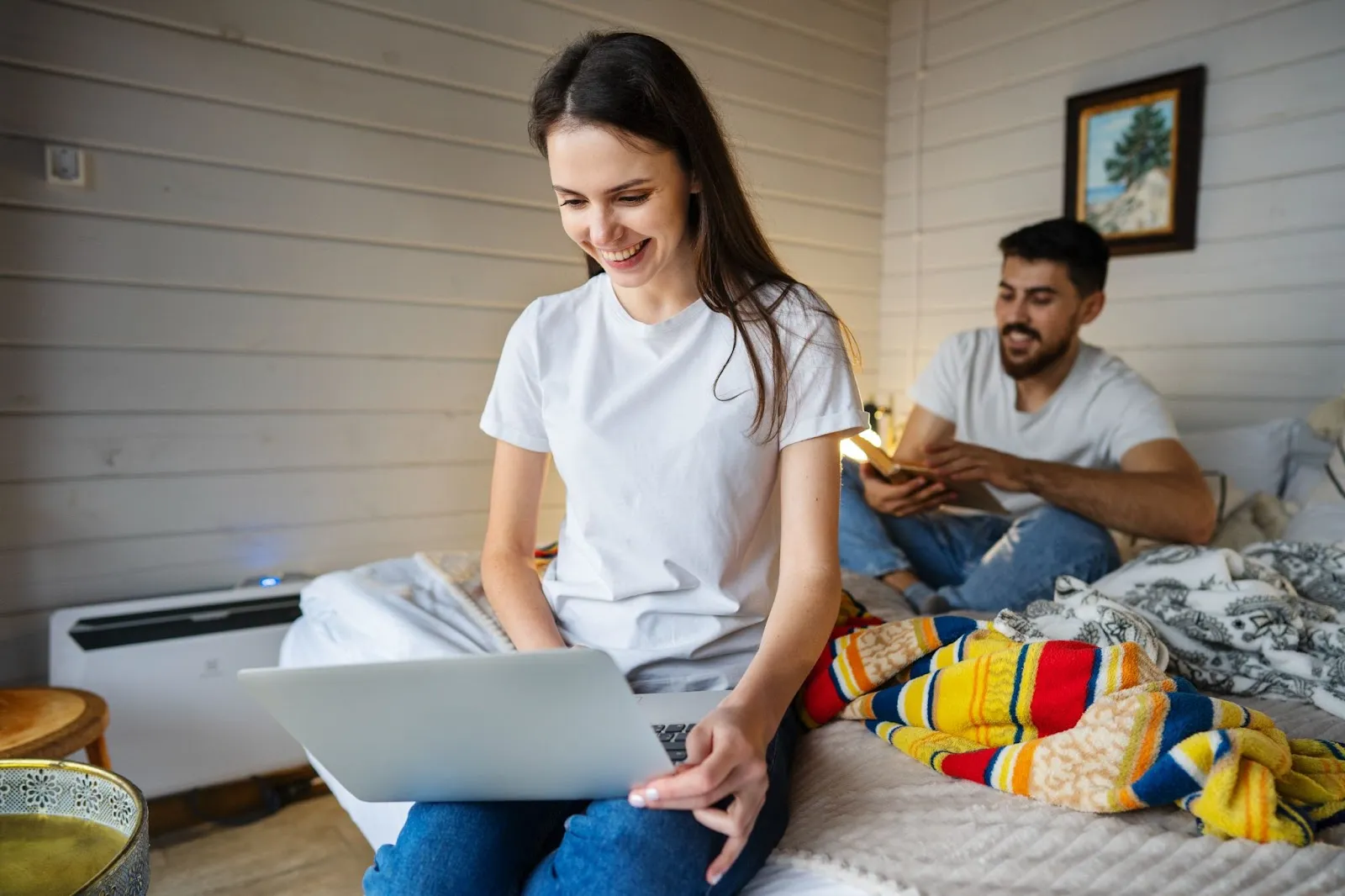A young woman using a laptop at home, smiling while browsing the internet. Text overlay reads: "Why Choose Windstream Somerset KY for Your Internet Needs.