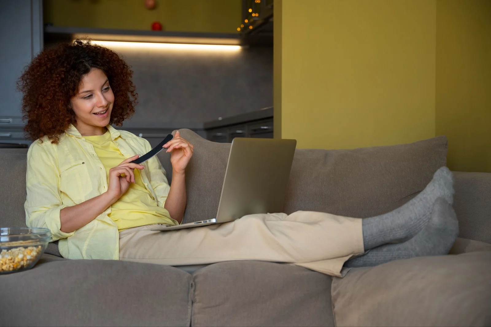 Young woman using a laptop at home, representing the importance of choosing the cheapest internet provider in the USA in 2025.