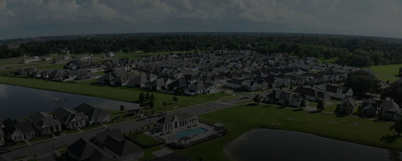 Aerial view of the Conway residential subdivision in Gonzales, LA, featuring houses, a large lake, and a community pool with a clubhouse, serving as a banner image for "Best Internet Providers in Gonzales, LA.