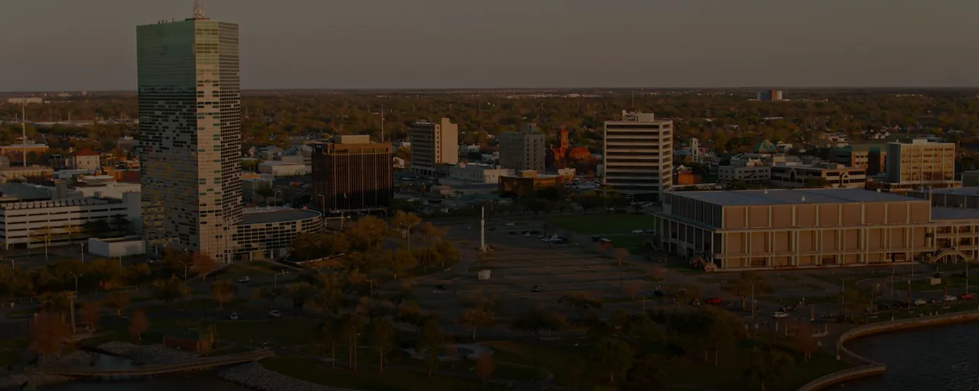 Aerial view of Lake Charles, Louisiana with city skyline and waterfront, representing top internet providers in Lake Charles, LA by Talk Walk Connection.