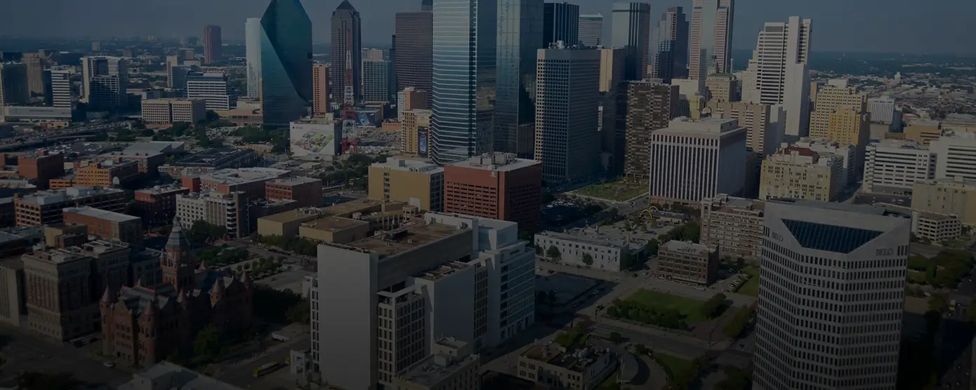 Aerial view of downtown Lewisville, Texas, showing city buildings, roads, and surrounding greenery, used as a banner image for a city page about exploring internet providers in Lewisville, TX.