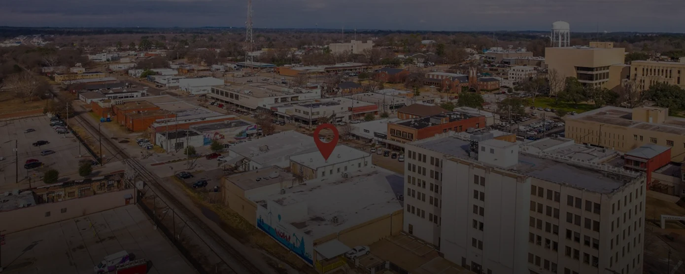 Aerial view of downtown Longview, Texas, featuring buildings and streets, used as a banner image for a city page about the best internet providers in Longview, TX.