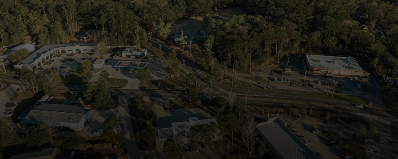 Aerial view of the commercial area along Highway 1088 in Mandeville, Louisiana, showing buildings, roads, and greenery, used as a banner image for finding the right internet provider in Mandeville, LA.