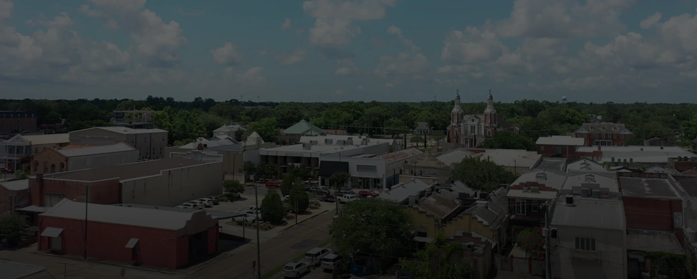 Aerial view of New Iberia, Louisiana, highlighting the cityscape with a distinctive church building visible in the distance, with overlay text that reads “Top Internet Providers New Iberia, LA.”