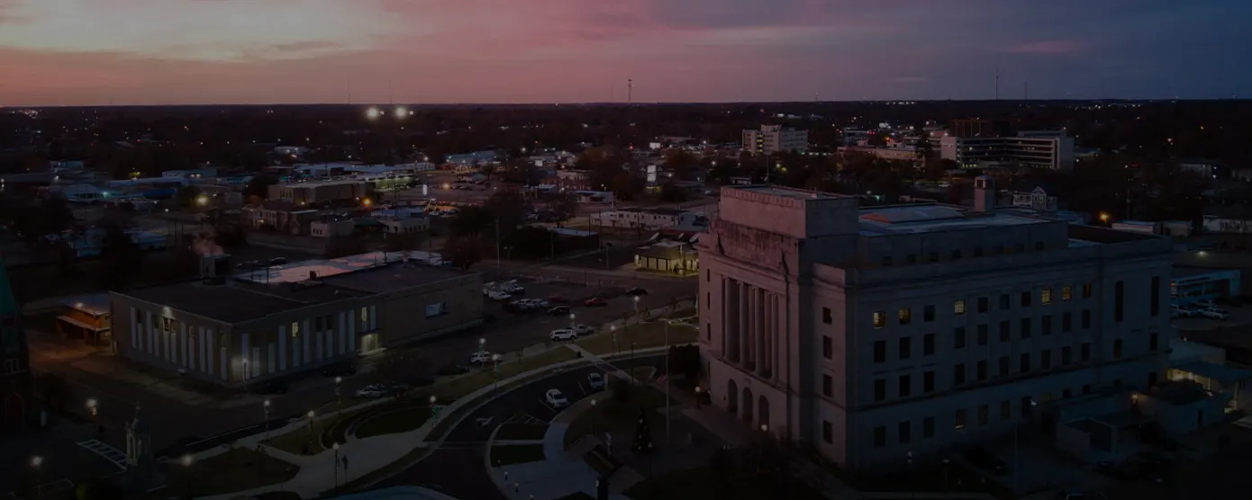 Aerial view of Texarkana, Texas, featuring the city layout, roads, and surrounding greenery with text “Reliable Internet Providers in Texarkana, TX: Talk Walk Connection Has Your Back.”