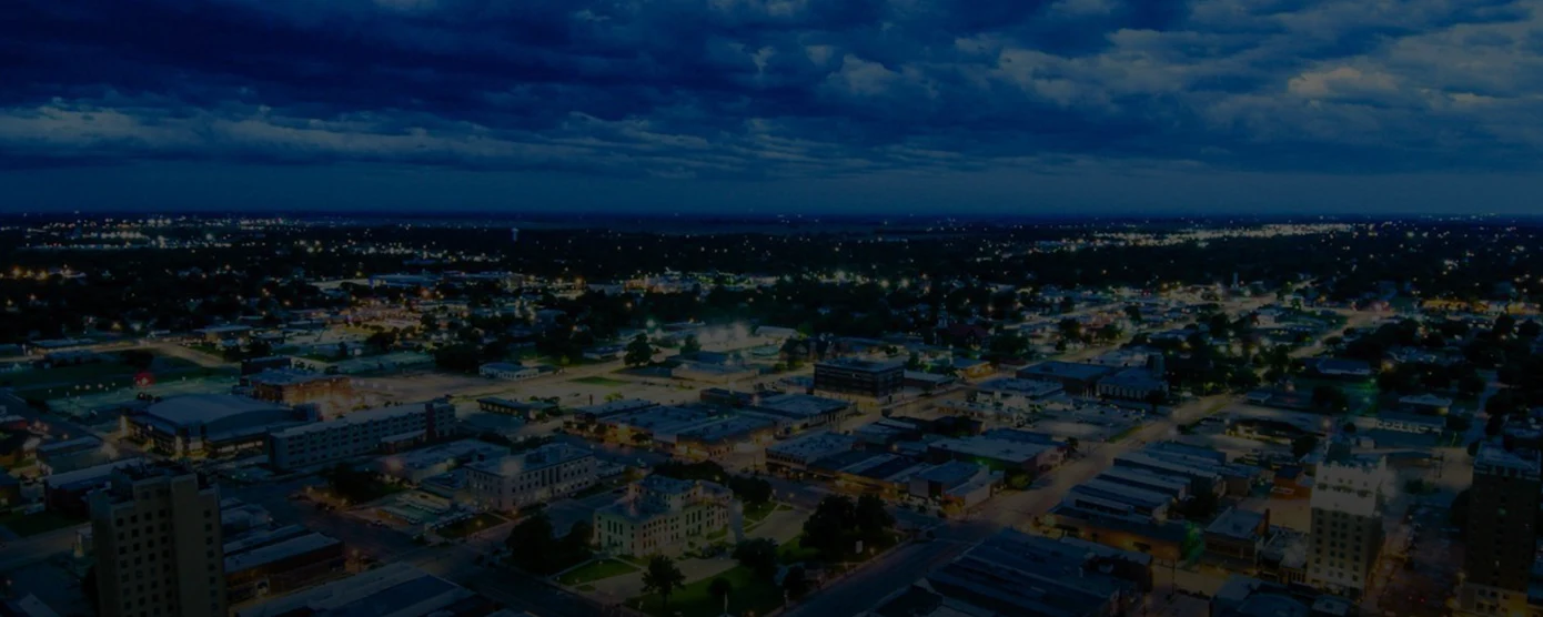 Aerial view of Enid, Oklahoma with homes and buildings, representing local internet coverage – banner for 'Internet Providers in Enid, OK – Your No-Guesswork Guide'